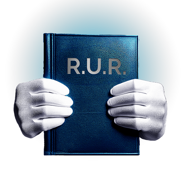 Ruce v bílých rukavicích držící knihu s nápisem R.U.R.